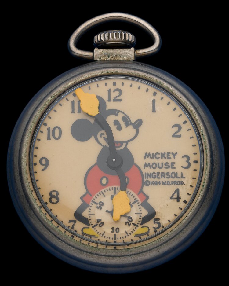Ingersoll Mickey Mouse pocket watch, 1934 W.D. Productions — chrome open-face case, cream dial, Mickey Mouse figure with yellow-glove hands pointing the hours and minutes, subsidiary seconds at 6