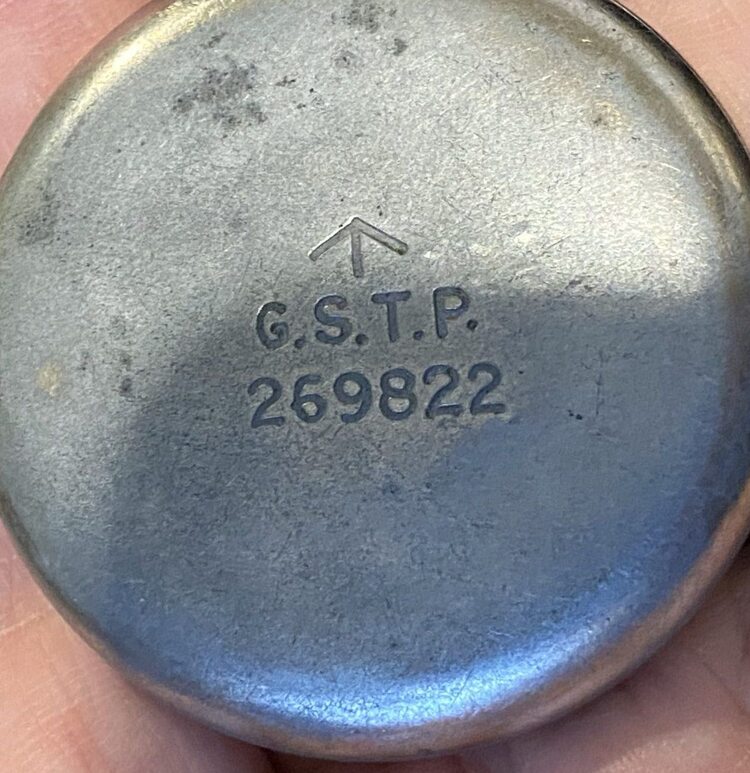 British military G.S.T.P. pocket watch caseback showing broad arrow above G.S.T.P. and stores number 269822