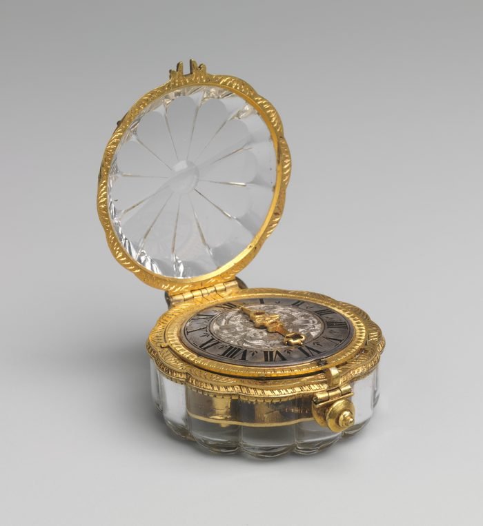 Lobed rock-crystal watch open, showing a silver dial with one gold hand