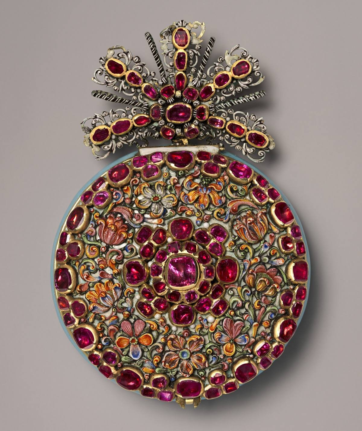 Watch case massed with red stones and painted enamel flowers under a jewelled bow