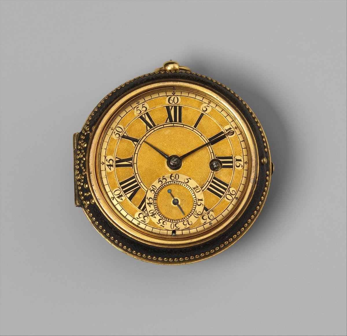 Gold watch dial with Roman hours, an outer ring numbered to sixty and two hands