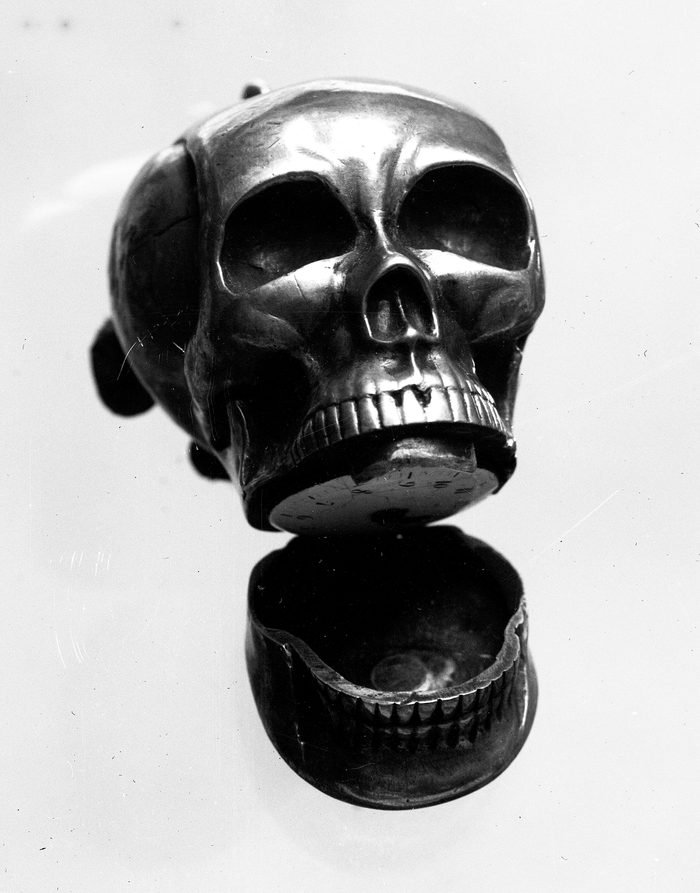 Skull watch with the lower jaw hinged open and a small dial inside the mouth
